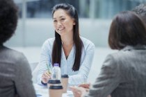 Smiling businesswoman in conference room meeting — Stock Photo