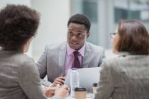 Businessman listening to colleagues in meeting — Stock Photo