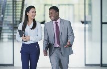 Smiling business people walking and talking — Stock Photo