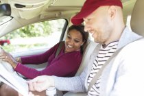 Couple looking at map in car on road trip — Stock Photo