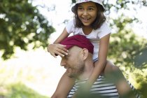 Vater trägt glückliche Tochter auf Schultern — Stockfoto