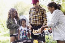 Family barbecuing at campsite — Stock Photo