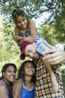 Happy, affectionate family taking selfie with camera phone — Stock Photo