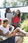 Mother fixing daughters hair at campsite — Stock Photo