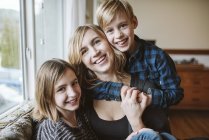 Portrait happy, affectionate mother and children — Stock Photo