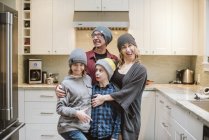 Portrait silly family making faces in kitchen — Stock Photo