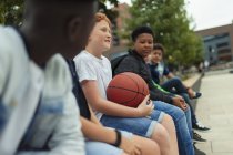 Tween boys with basketball in schoolyard — Stock Photo