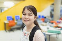 Portrait confident junior high girl student in library — Stock Photo