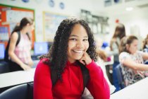 Portrait of smiling, confident junior high school girl in classroom — Stock Photo