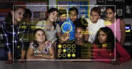 Junior high school students using futuristic touch screen in classroom — Stock Photo