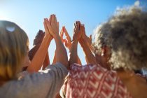 Group with hands clasped in circle during yoga retreat — Stock Photo