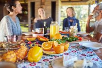 Friends enjoying healthy breakfast at table during yoga retreat — Stock Photo