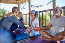 Yoga class meditating in hut during yoga retreat — Stock Photo