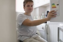 Portrait confidant young woman in wheelchair in apartment kitchen — Stock Photo