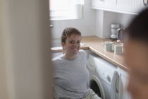 Retrato confiante jovem mulher em cadeira de rodas na cozinha apartamento — Fotografia de Stock