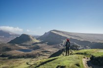 Female hiker looking at sunny landscape view, Isle of Skye, Scotland — Stock Photo