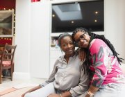 Portrait happy mother and adult daughter in living room — Stock Photo