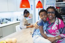 Portrait affectionate grandmother and grandson in kitchen — Stock Photo