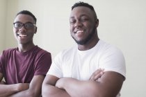 Portrait confident teenage brothers with arms crossed — Stock Photo