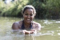 Щаслива жінка плаває в річці — стокове фото