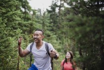 Happy couple hiking in woods — Stock Photo