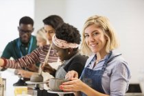 Portrait confident women making clay bowl in art class — Stock Photo