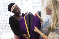 Female fashion designers working at dressmakers model — Stock Photo