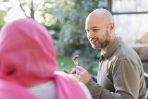 Man eating with wife in hijab — Stock Photo