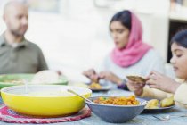 Family eating dinner at table — Stock Photo
