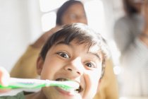 Портрет игривый, глупый мальчик чистит зубы — стоковое фото