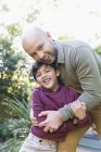 Portrait happy father and son hugging — Stock Photo