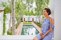 Laughing, carefree woman on hotel balcony — Stock Photo