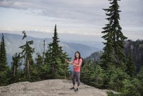 Portrait happy young woman hiking at mountaintop, Dog Mountain, BC, Canada — Stock Photo