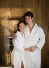 Retrato casal feliz em roupões de banho no spa — Fotografia de Stock