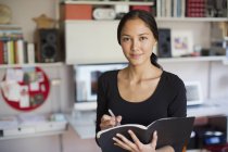 Portrait confident young woman working in home office — Stock Photo