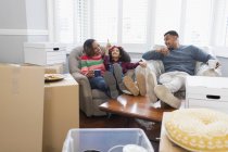 Family taking a break from moving house — Stock Photo