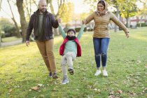 Playful Muslim family in autumn park — Stock Photo
