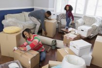 Family packing moving boxes, moving house — Stock Photo
