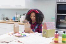 Girl painting house crafts in kitchen — Stock Photo