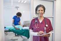 Portrait confident female doctor working in clinic — Stock Photo