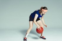 Adolescente jogador de basquete driblando bola — Fotografia de Stock