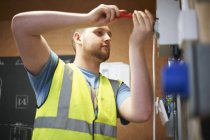 Male electrician student using screwdriver — Stock Photo