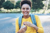 Portrait of happy, confident young woman with water bottle — Stock Photo