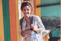 Портрет улыбающейся, уверенной молодой женщины на солнечном патио — стоковое фото