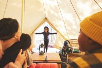 Family watching happy girl enter camping yurt — Stock Photo