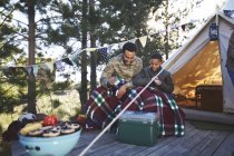 Vater und Sohn spielen vor Jurte auf Campingplatz Karten — Stockfoto