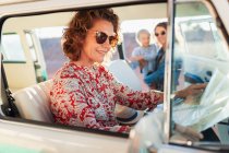 Woman with map in van — Stock Photo