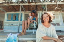 Portrait happy multi-generation women on beach hut patio — Stock Photo