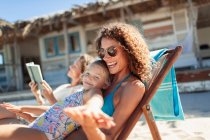 Happy mother and daughter on sunny beach — Stock Photo