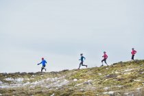 Friends jogging in snow — Stock Photo